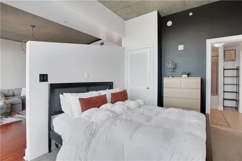 a bedroom with a bed and a couch