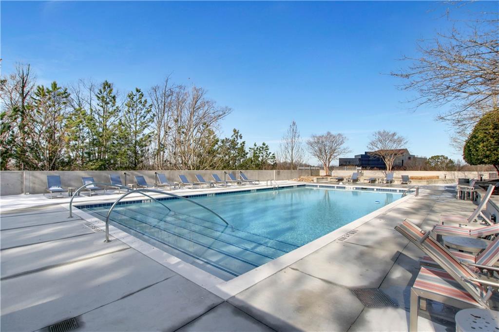 3300 Windy Ridge Parkway Southeast, Unit 1603 Atlanta, GA 30339 - Photo 27 of 39 a view of a swimming pool with a yard and seating area