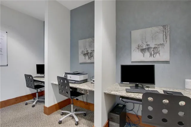 a view of a workspace with furniture and wooden floor