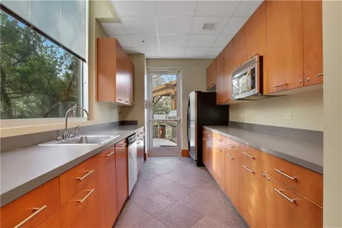 a kitchen with stainless steel appliances granite countertop a sink and a stove