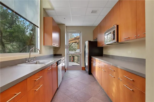 a kitchen with stainless steel appliances granite countertop a sink and a stove