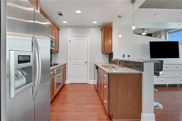 a kitchen with stainless steel appliances a refrigerator and a stove