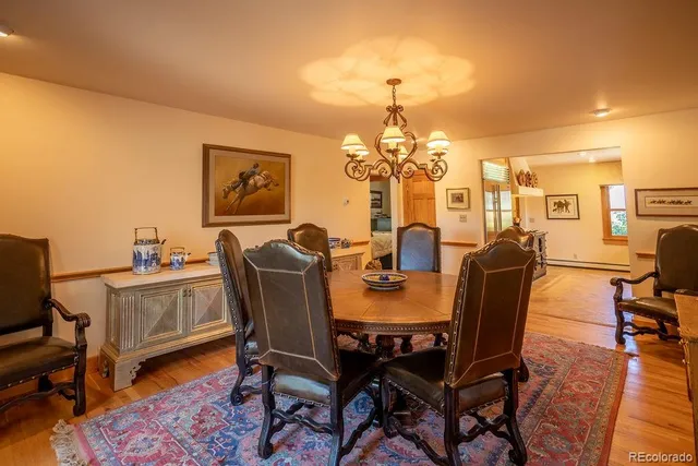 a view of a dining room with furniture and chandelier