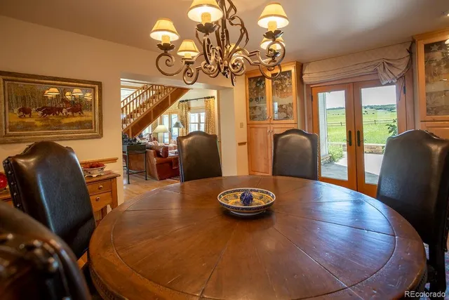 a view of a dining room with furniture wooden floor and chandelier