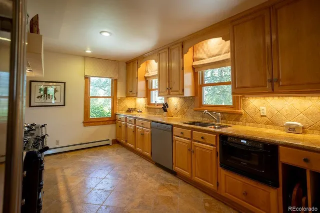 a kitchen with stainless steel appliances a sink stove and cabinets