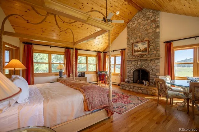 a spacious bedroom with a bed and a fireplace