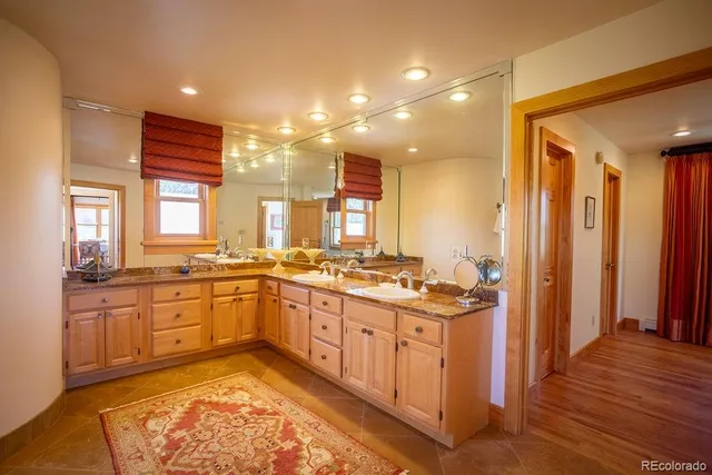 a large kitchen with stainless steel appliances granite countertop a stove and large window