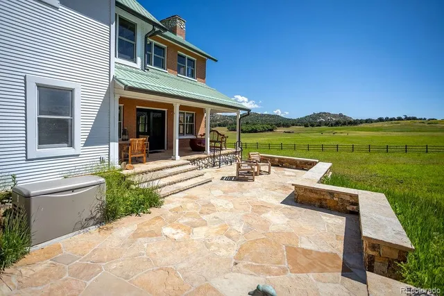 a view of a house with pool and a yard