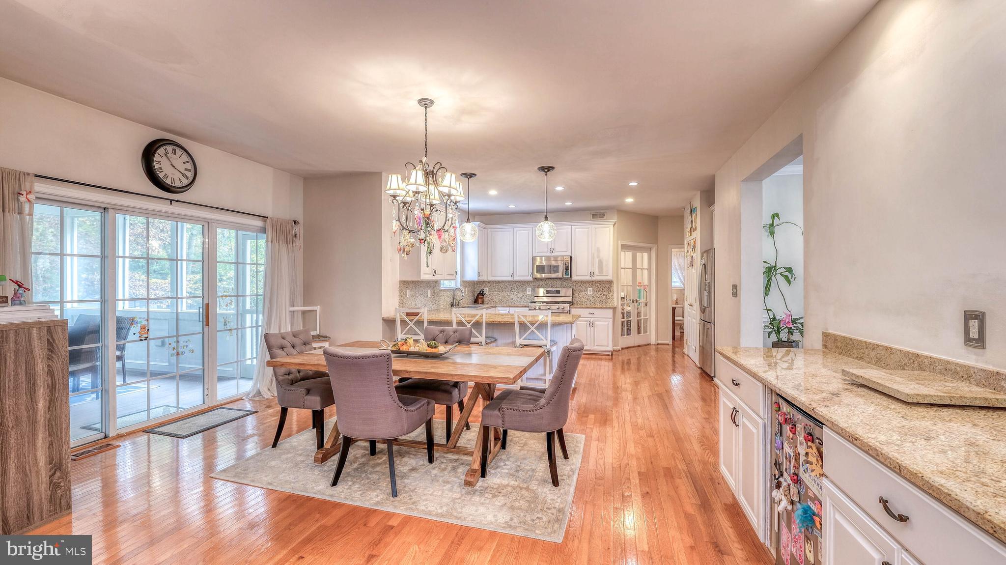 107 Millstone Way Monroeville, NJ 08343 - Photo 13 of 40 a view of a dining room and livingroom with furniture wooden floor a chandelier