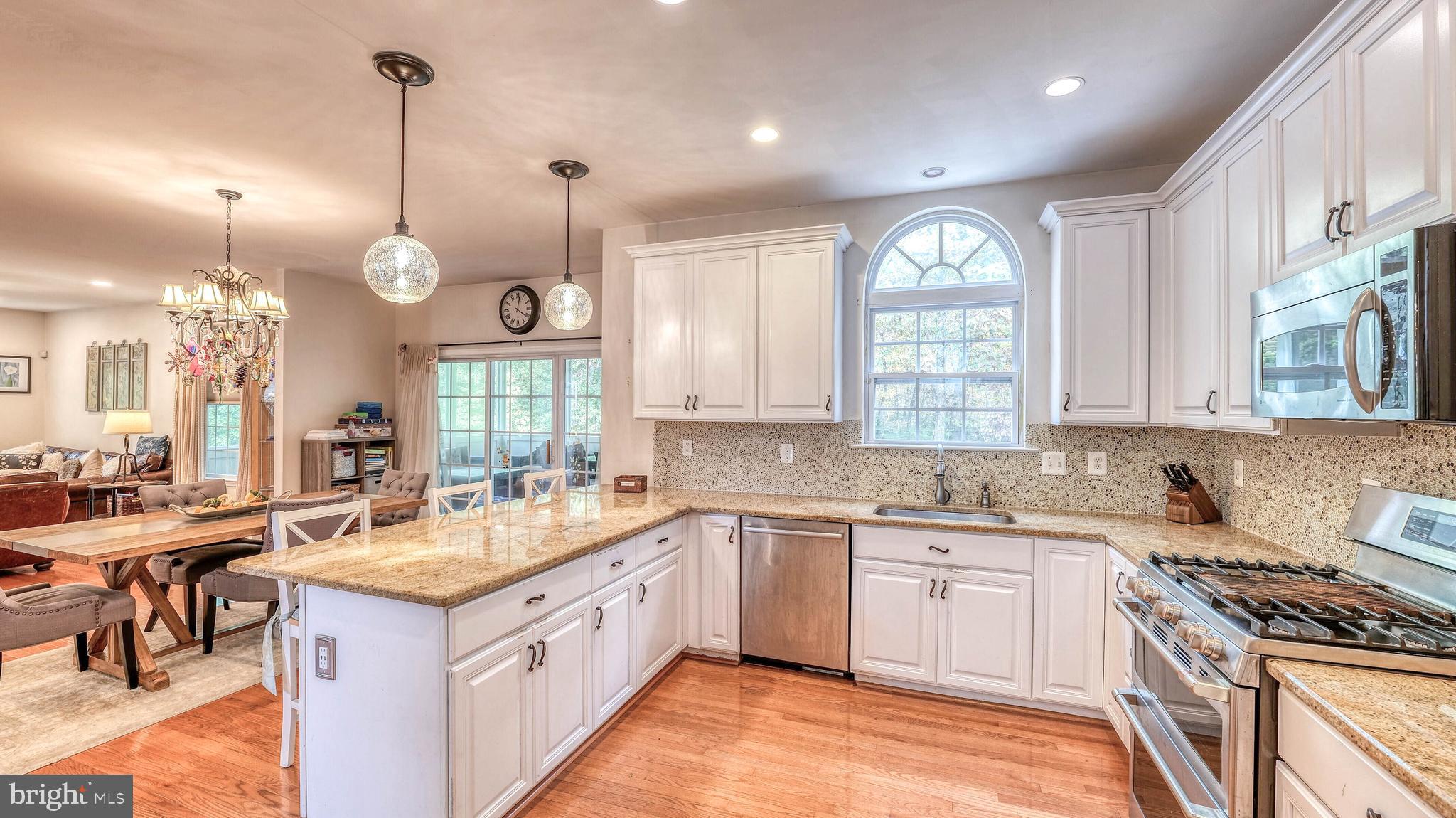 107 Millstone Way Monroeville, NJ 08343 - Photo 19 of 40 a kitchen with a sink stove and cabinets
