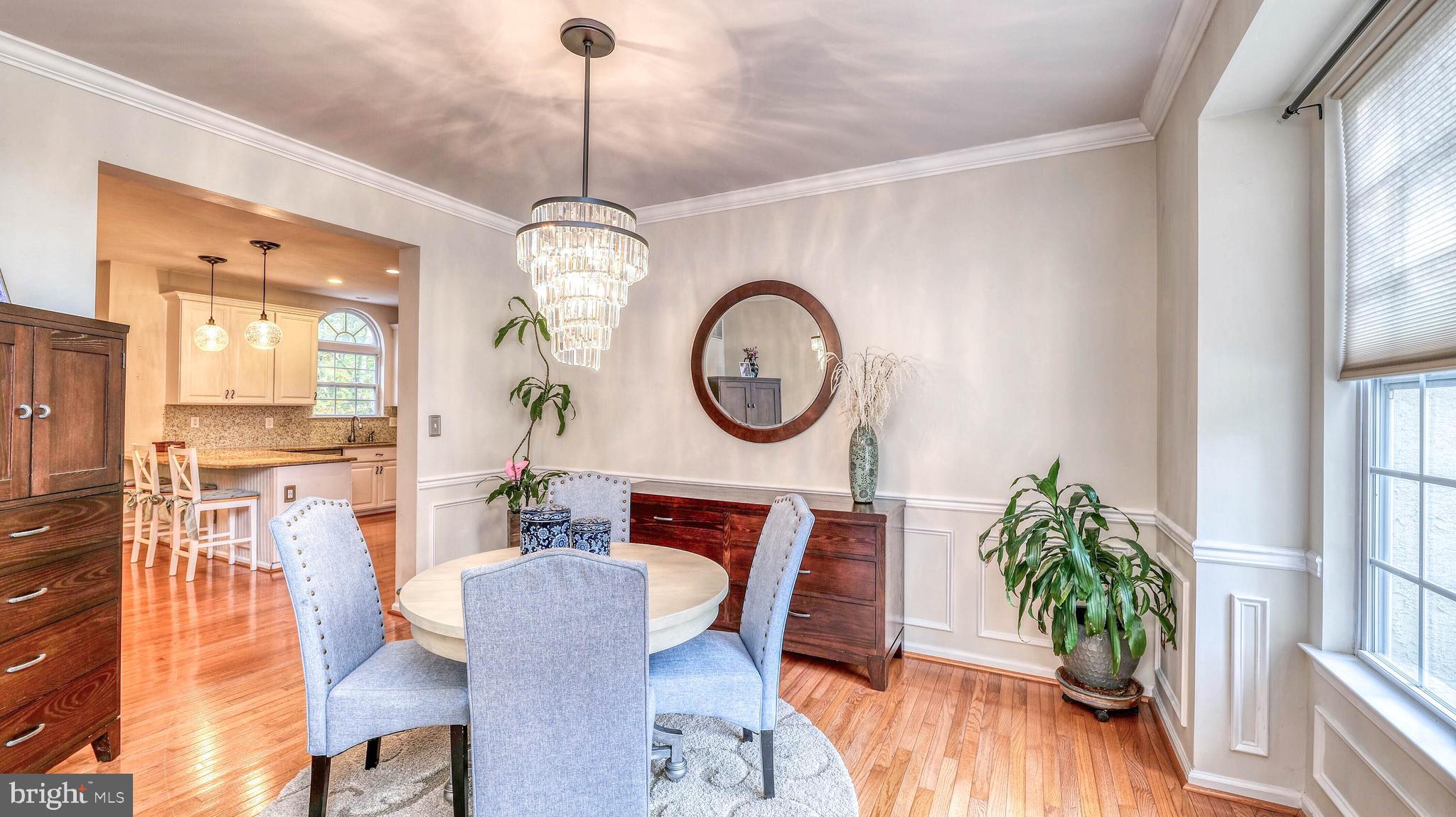 107 Millstone Way Monroeville, NJ 08343 - Photo 22 of 40 a dining room with furniture potted plants and wooden floor