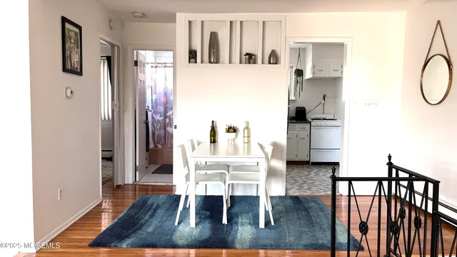 a dining room with furniture and wooden floor