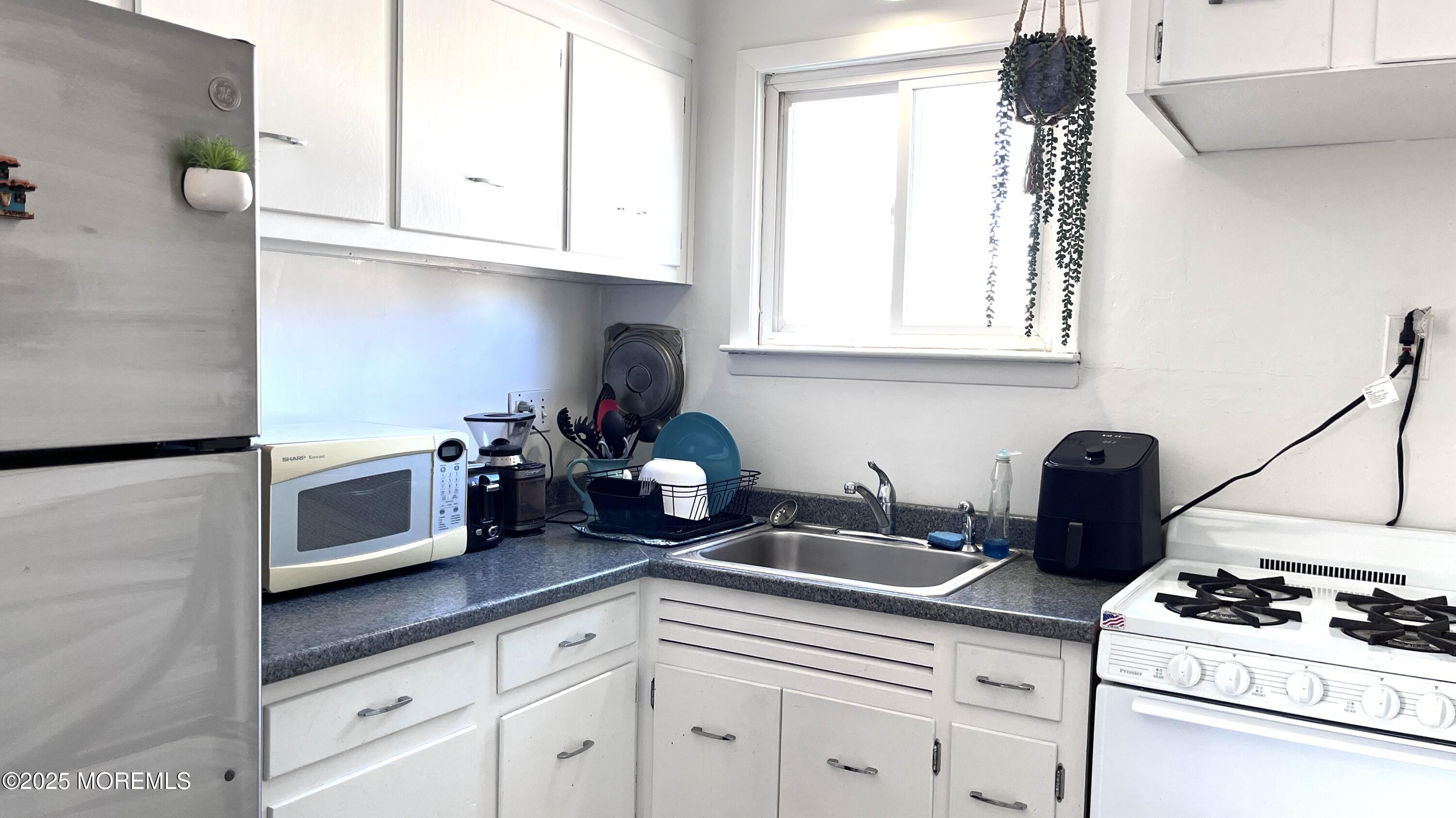 35 Sternberger Avenue, Unit K Long Branch, NJ 07740 - Photo 5 of 6 a kitchen with appliances a sink and cabinets