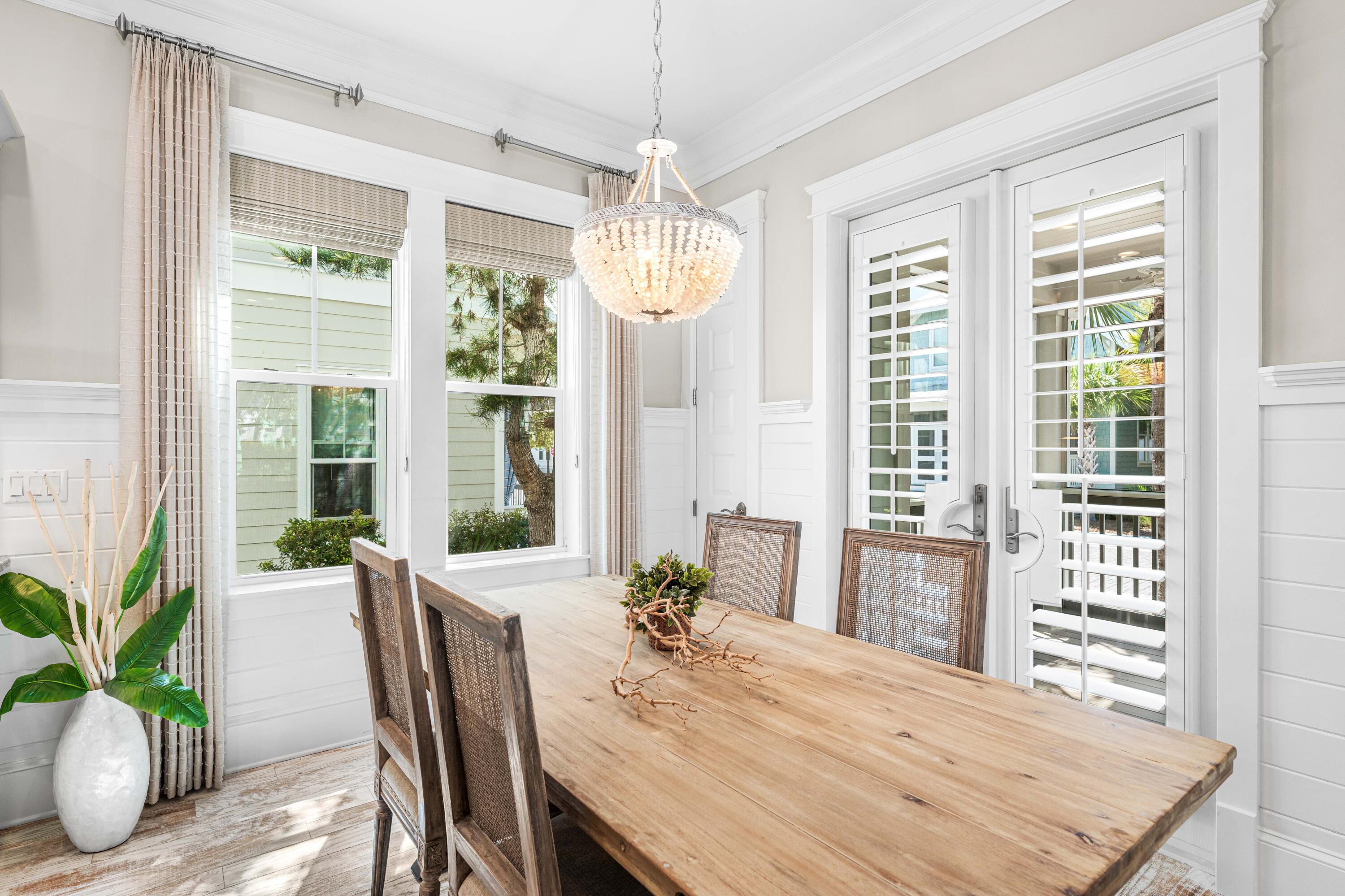 27 Federal Street Inlet Beach, FL 32461 - Photo 23 of 74 a view of a dining room with furniture window and wooden floor