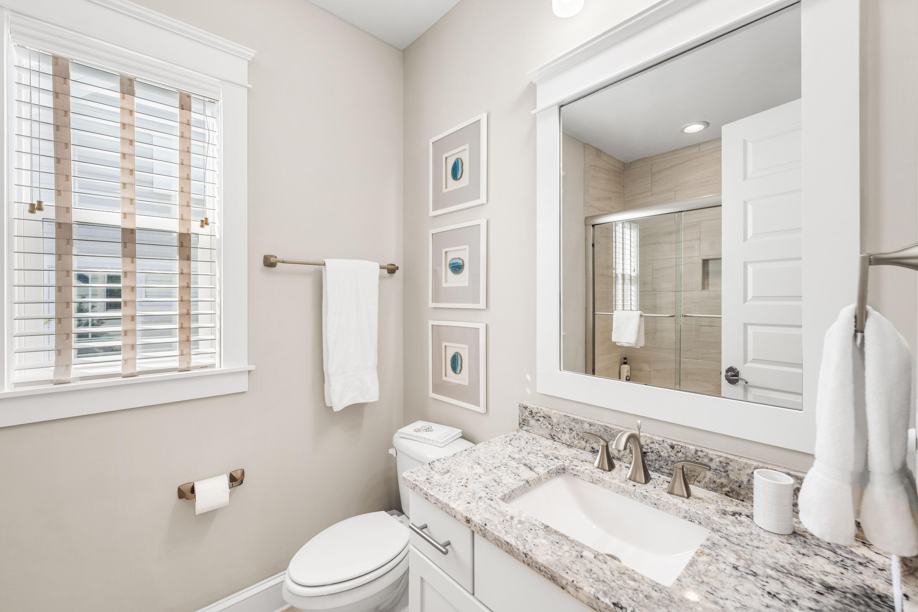 27 Federal Street Inlet Beach, FL 32461 - Photo 50 of 74 a bathroom with a granite countertop sink toilet a large mirror and a window