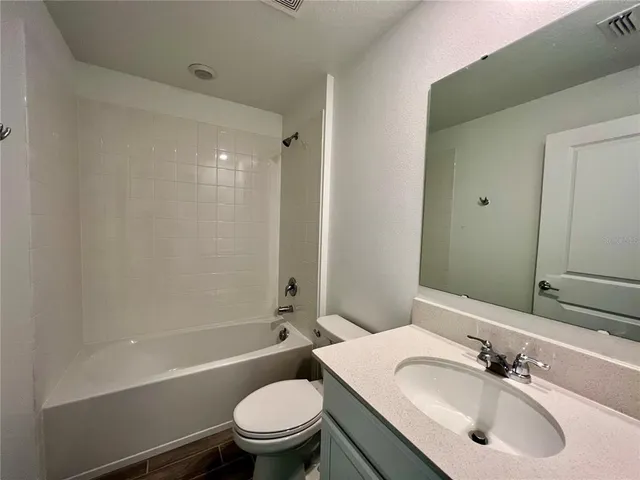 a bathroom with a sink toilet tub and shower