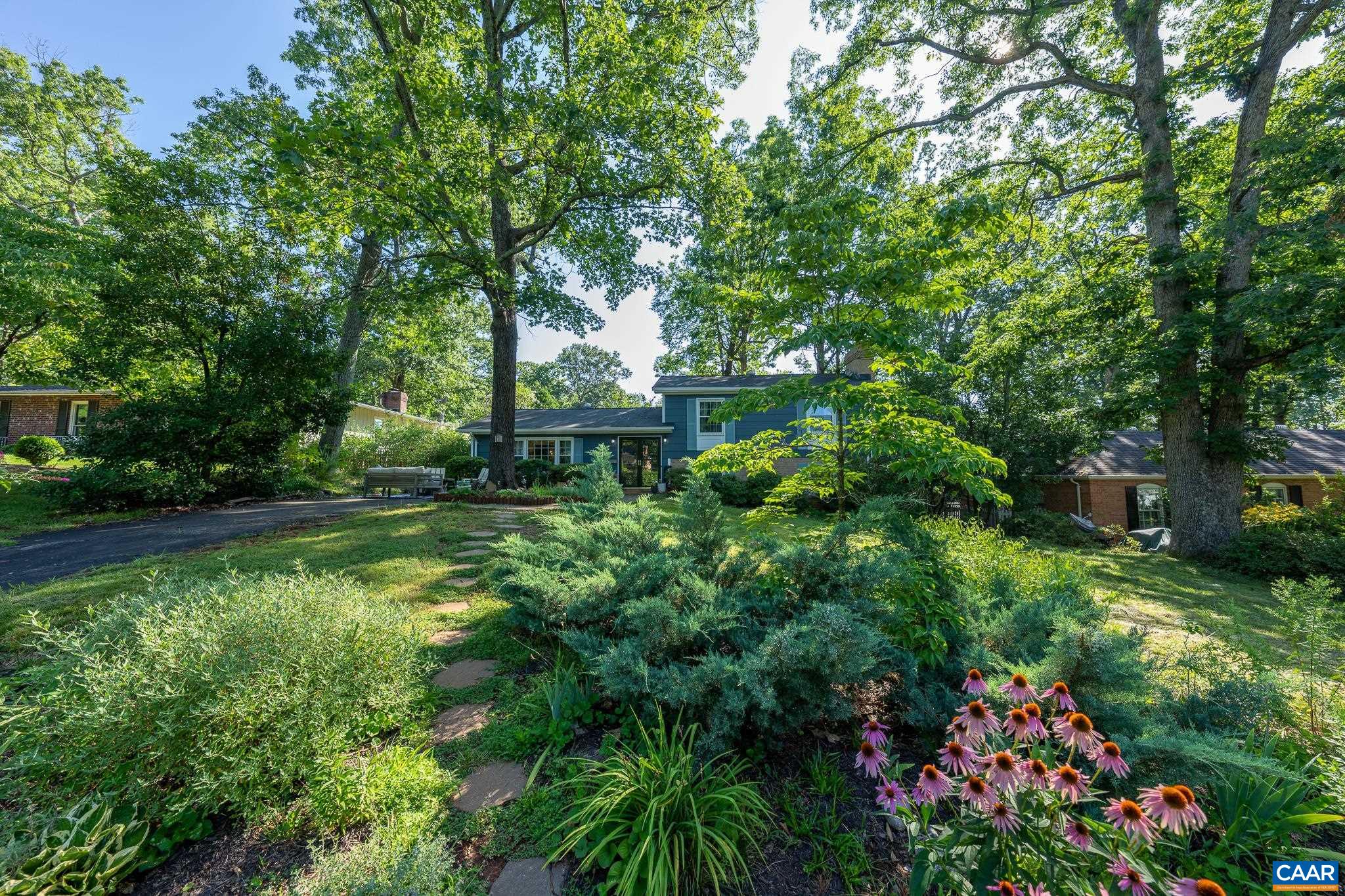 723 Village Road Charlottesville, VA 22903 - Photo 4 of 51 a backyard of a house with lots of green space and fountain