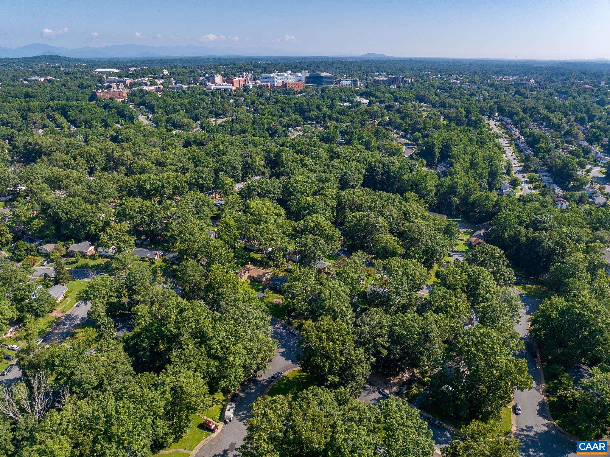 723 Village Road Charlottesville, VA 22903 - Photo 47 of 51 an aerial view of a city with lots of residential buildings and mountain view in back