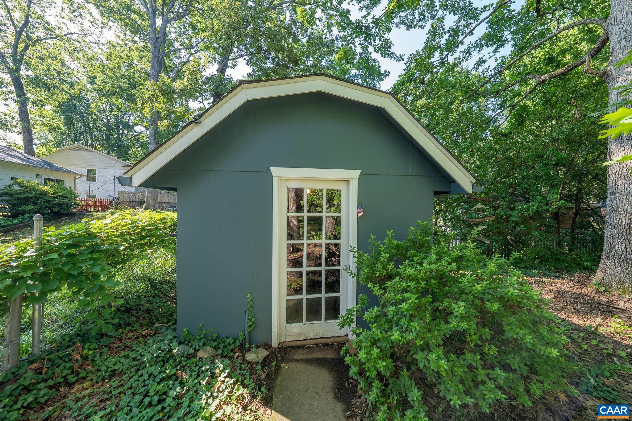 723 Village Road Charlottesville, VA 22903 - Photo 7 of 51 a house with a small yard plants and large trees