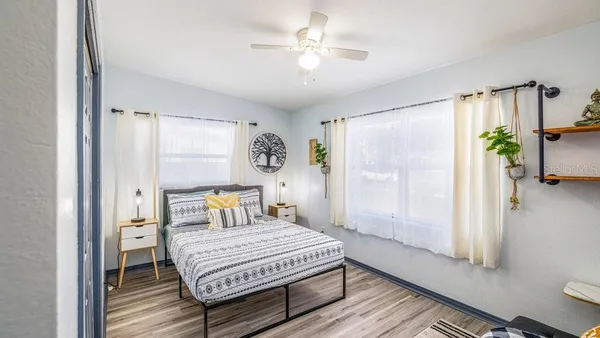 a bedroom with a bed table and a window