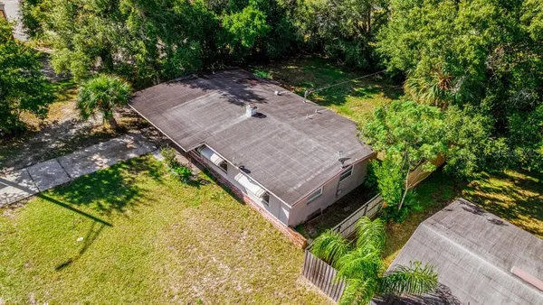 an aerial view of a house with a yard