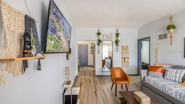 a living room with furniture and large windows