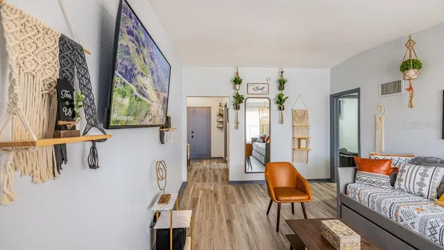 a living room with furniture and large windows