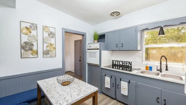 a kitchen with a sink cabinets and window