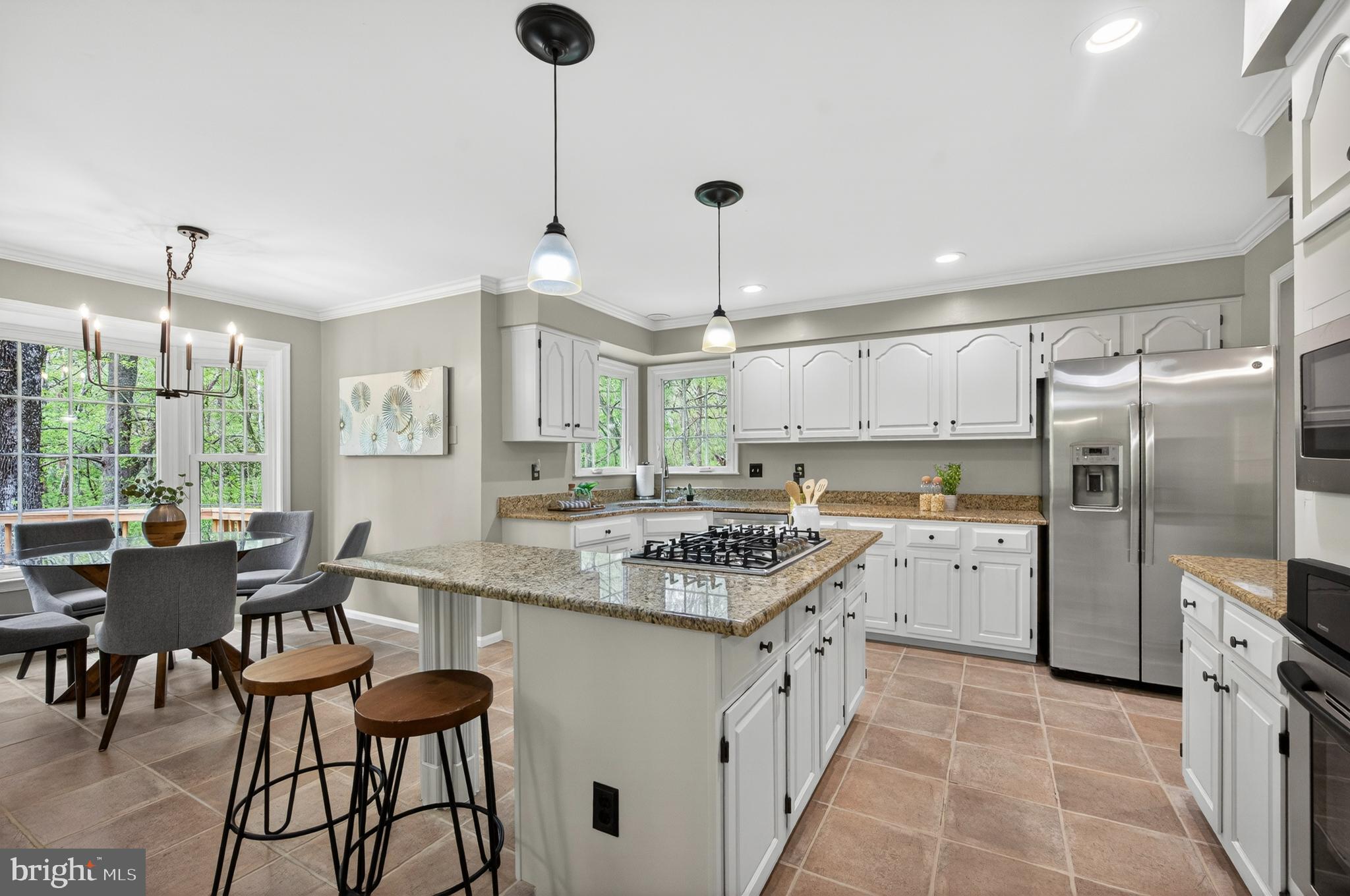 2906 Oakton Ridge Circle Oakton, VA 22124 - Photo 12 of 42 a kitchen with stainless steel appliances granite countertop a sink a stove a refrigerator and chairs