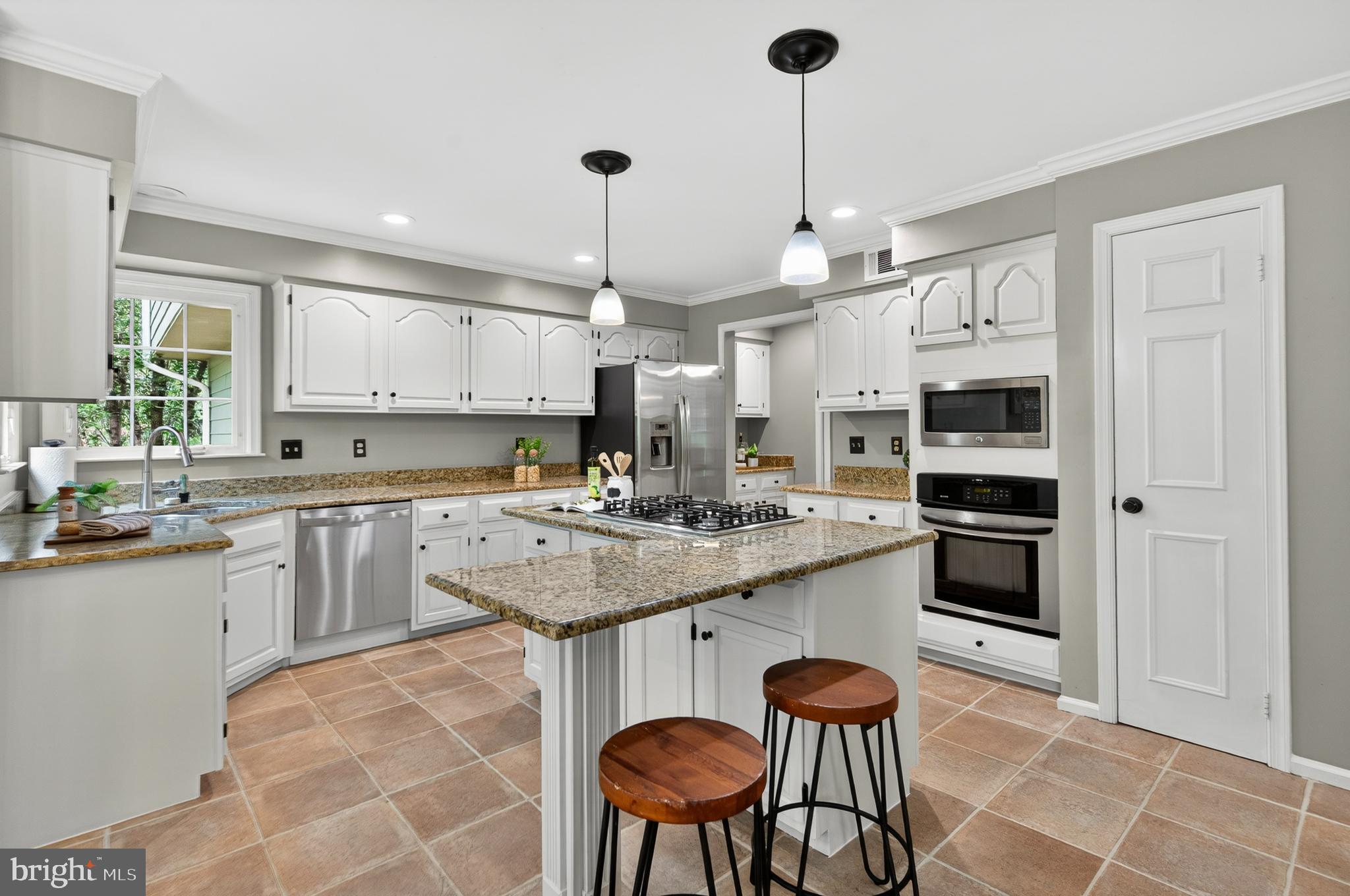 2906 Oakton Ridge Circle Oakton, VA 22124 - Photo 13 of 42 a kitchen with stainless steel appliances granite countertop a sink a stove a refrigerator and chairs