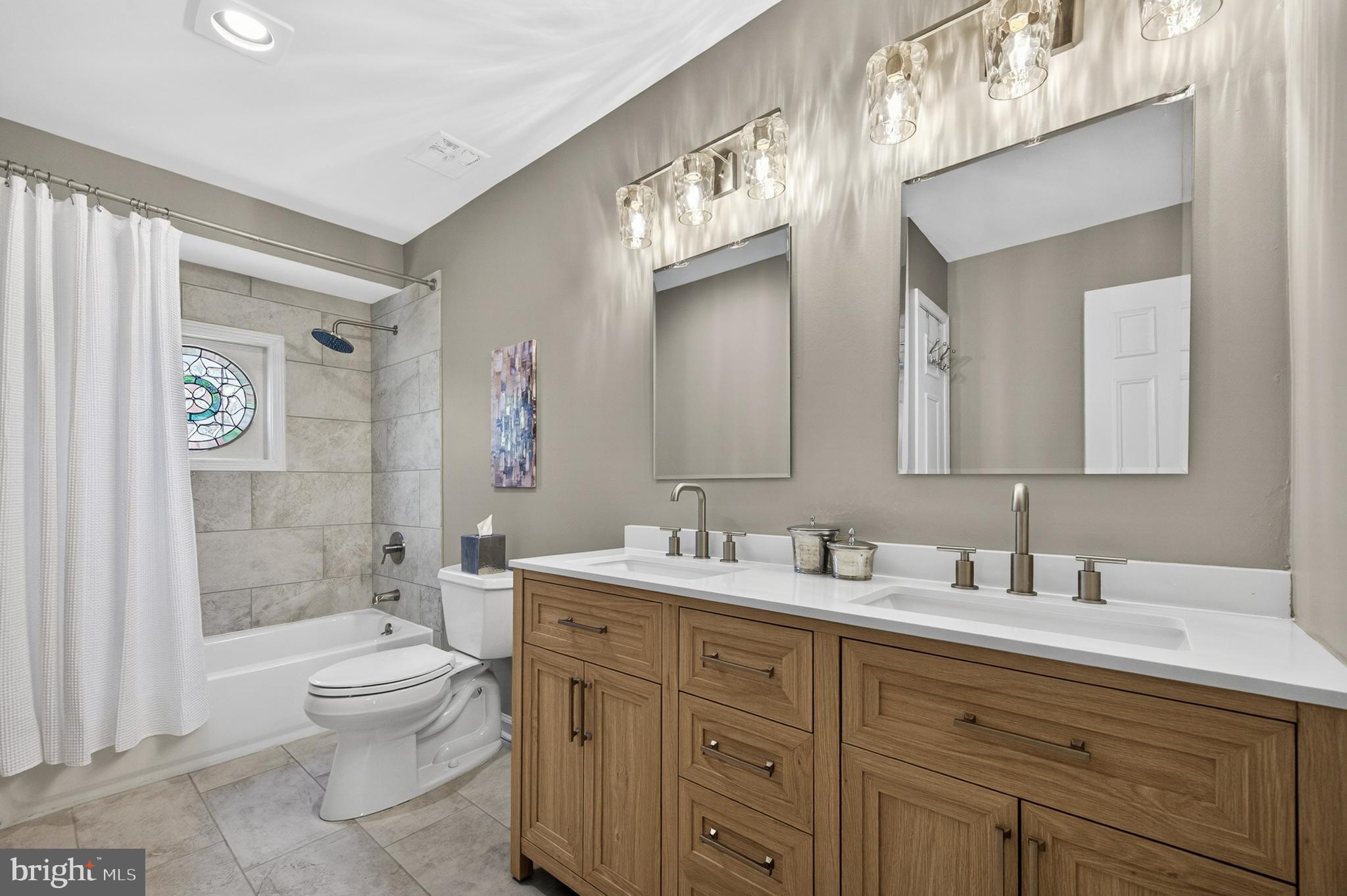 2906 Oakton Ridge Circle Oakton, VA 22124 - Photo 27 of 42 a bathroom with double vanity sink a toilet and a mirror