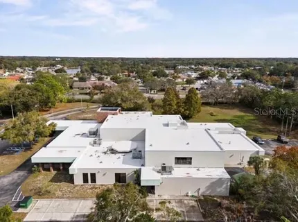 an aerial view of a residential houses with city view