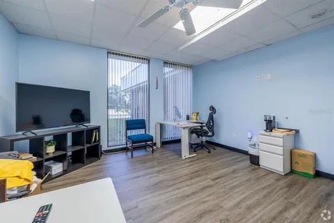a living room with furniture and a wooden floor