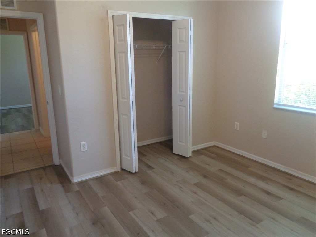 2463 Nature Pointe Loop Fort Myers, FL 33905 - Photo 36 of 50 an empty room with wooden floor and closet