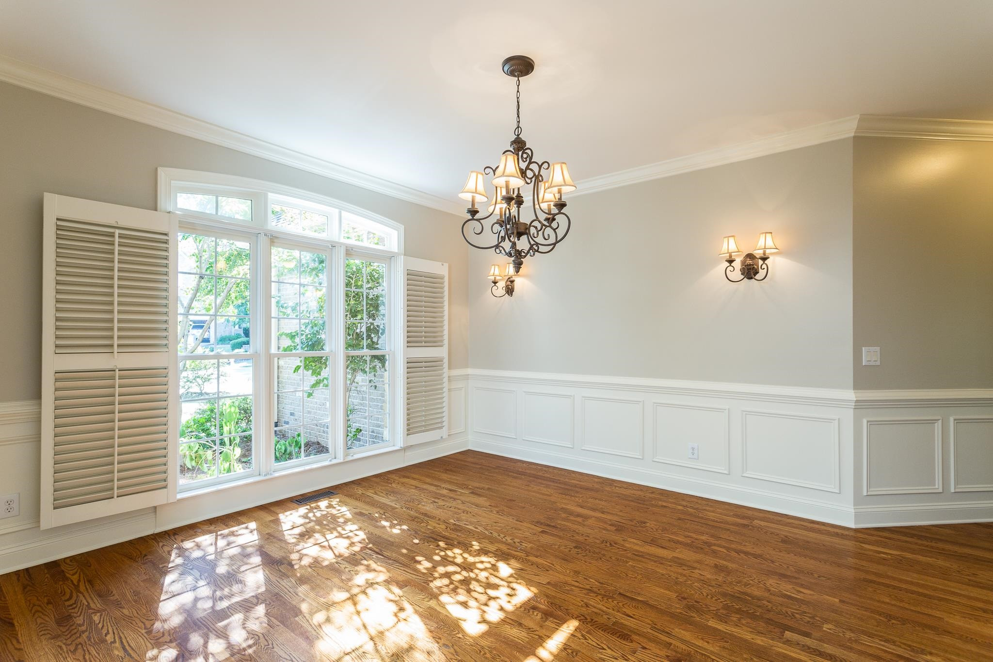 Hardwood floors, crown molding, chair rail, wainscoting and plantation shutters. Dining Room