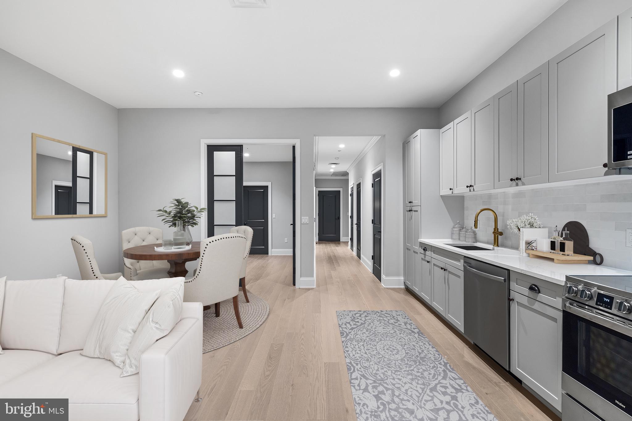 200 South Broad Street, Unit 1015 Philadelphia, PA 19102 - Photo 11 of 48 a living room with furniture and kitchen view