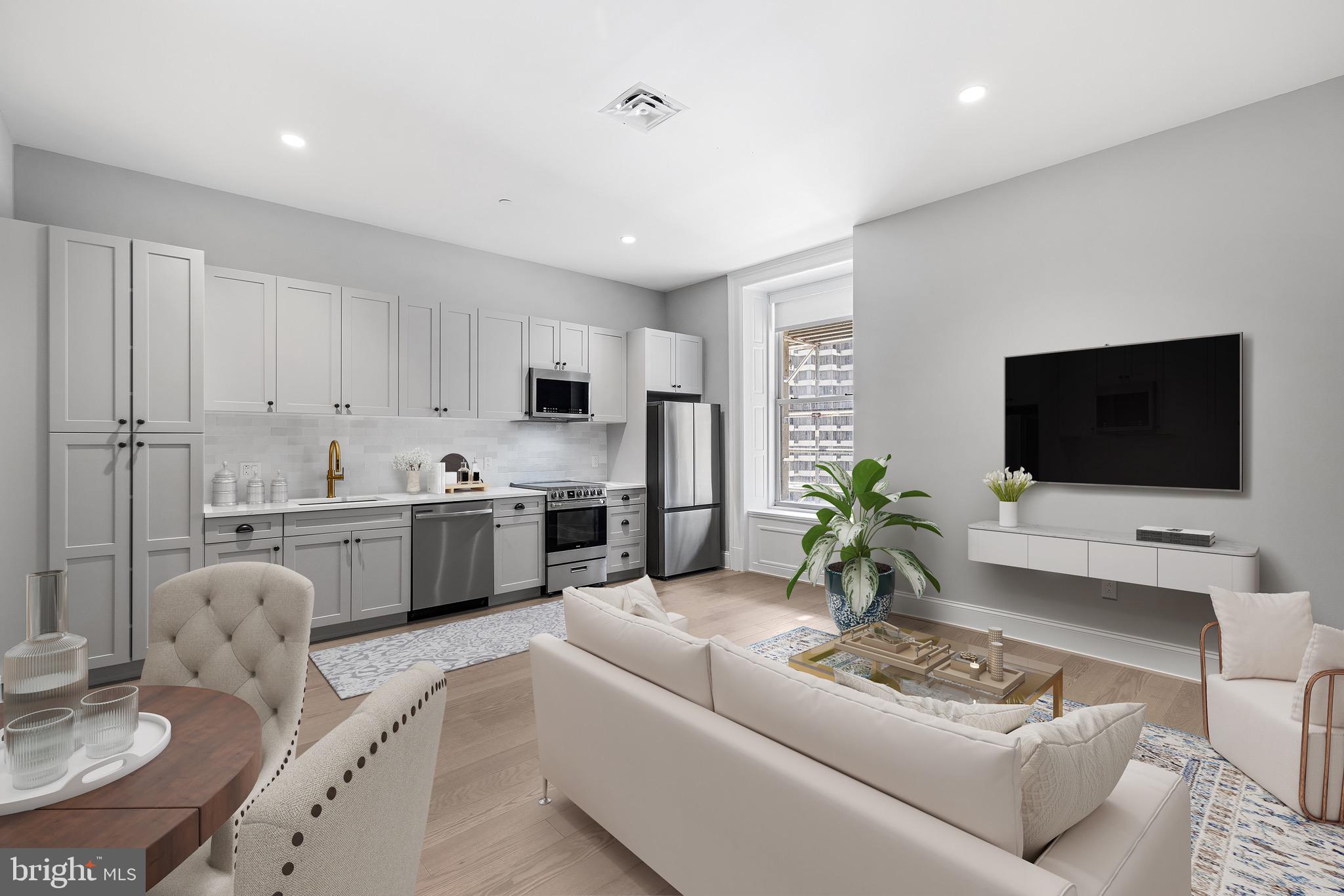 200 South Broad Street, Unit 1015 Philadelphia, PA 19102 - Photo 13 of 48 a living room with furniture a flat screen tv and kitchen view
