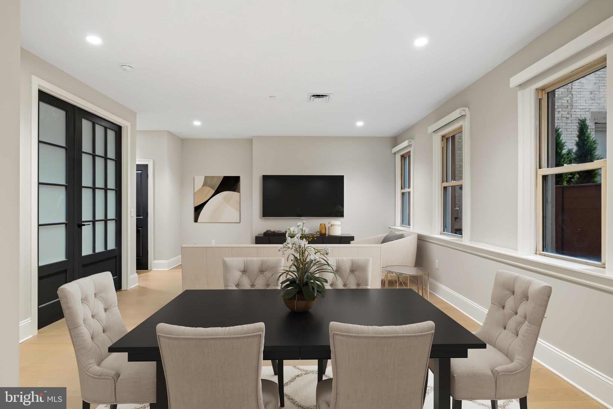 200 South Broad Street, Unit 1015 Philadelphia, PA 19102 - Photo 9 of 48 a living room with furniture a flat screen tv and a large window
