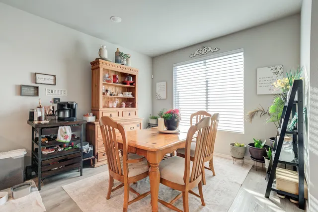 a dining room with furniture and a window