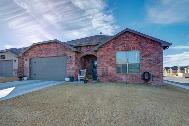 a view of a brick house with a yard