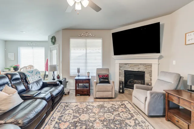 a living room with furniture fireplace and flat screen tv