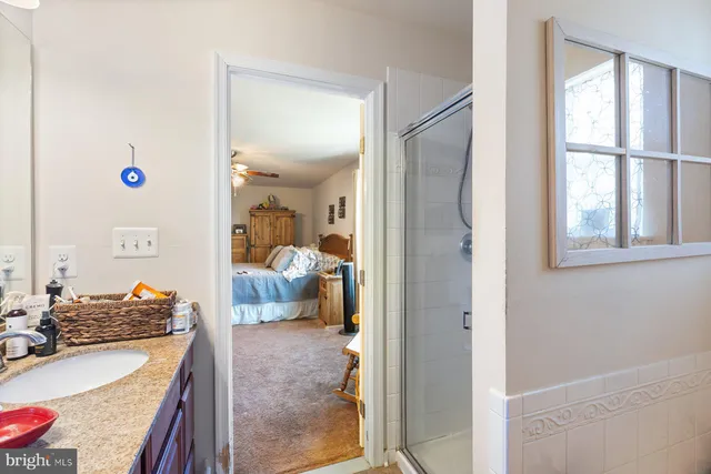 a bathroom with a granite countertop sink and a mirror