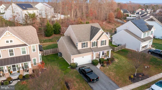 an aerial view of multiple houses with a yard