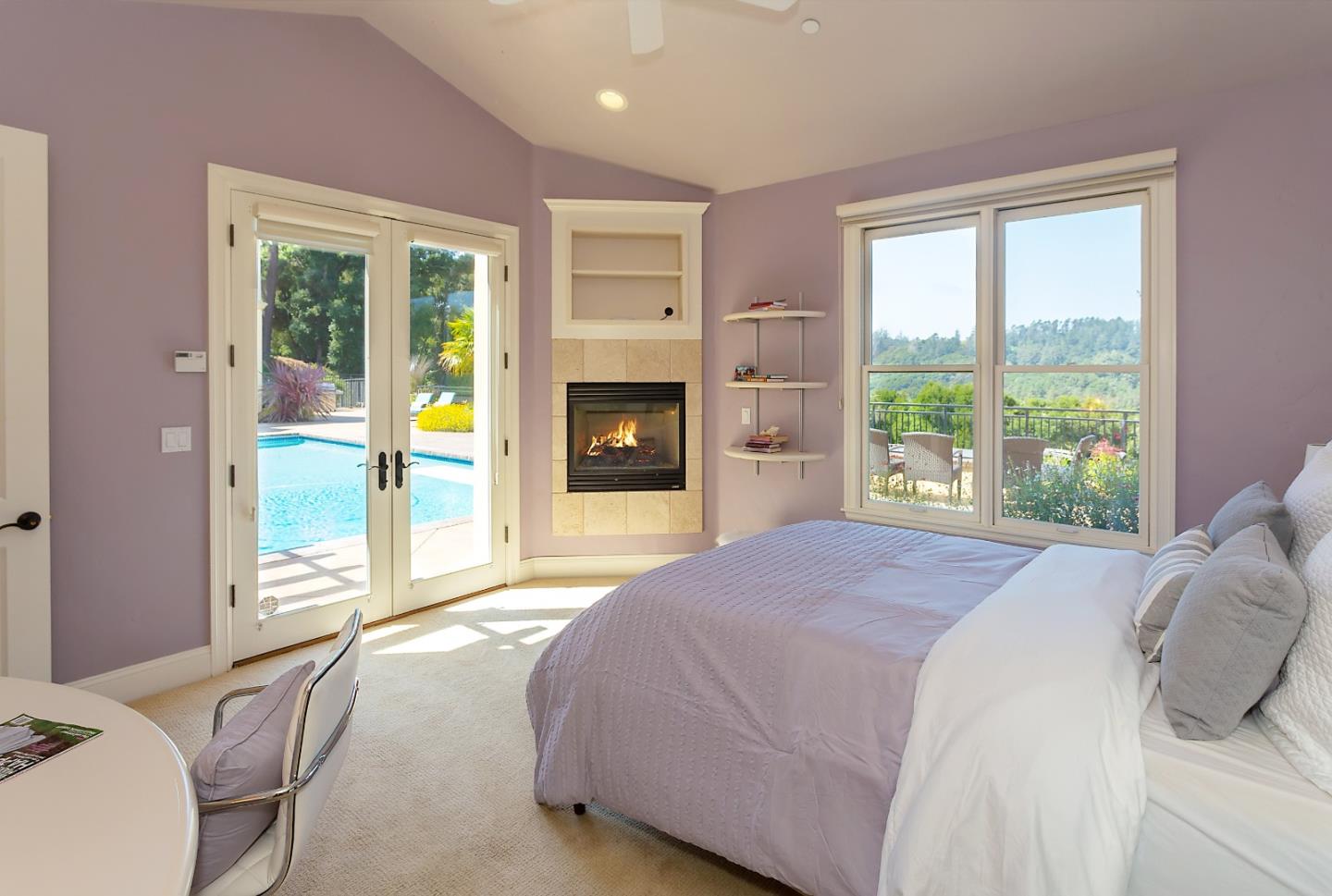 595 Day Valley Road Aptos, CA 95003 - Photo 13 of 37 a spacious bedroom with a large bed and a fireplace