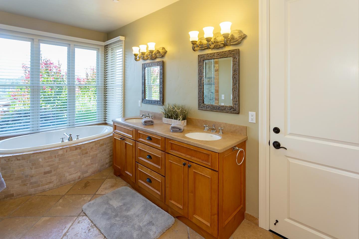 595 Day Valley Road Aptos, CA 95003 - Photo 17 of 37 a bathroom with a double vanity sink a large mirror and a bathtub