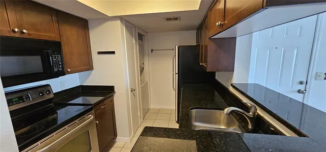 a kitchen that has a sink and a stove
