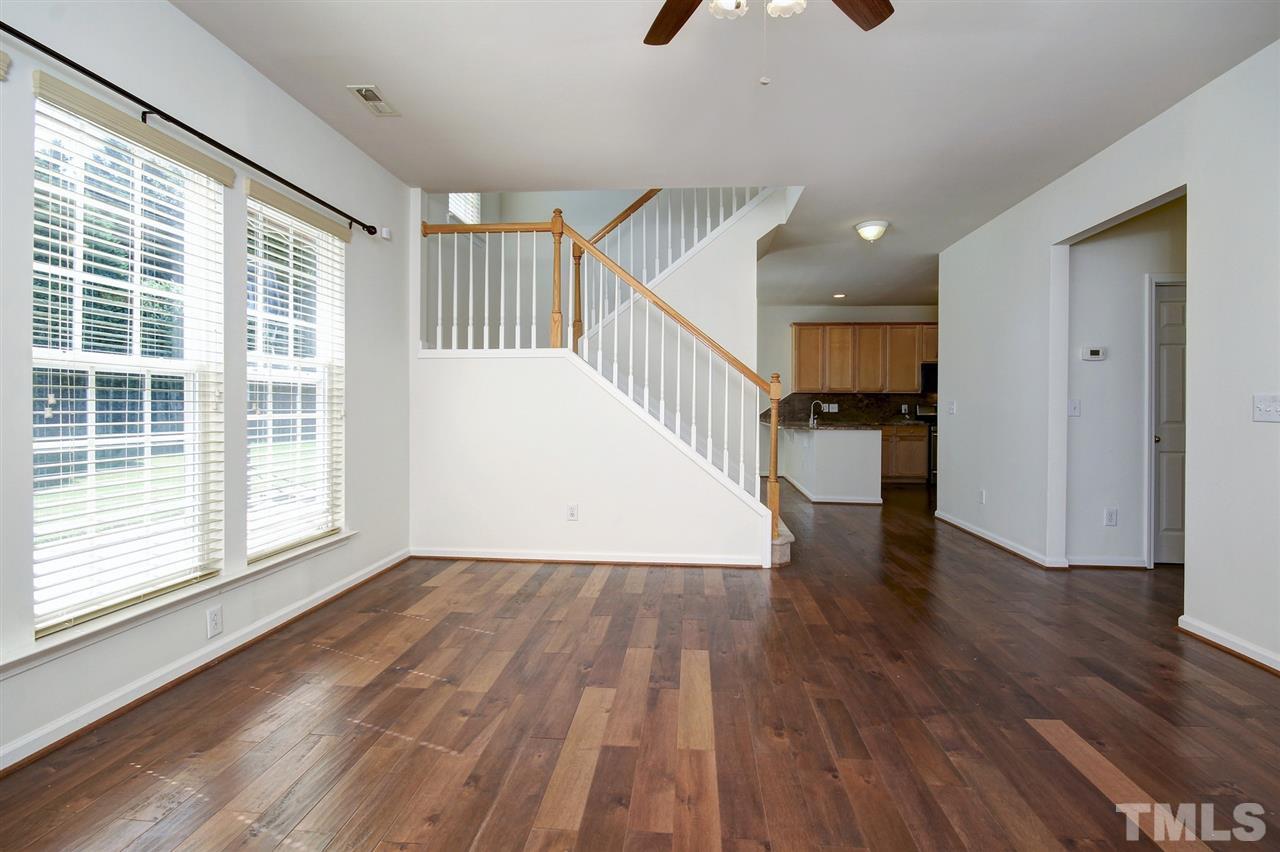 7444 Lagrange Drive Raleigh, NC 27613 - Photo 12 of 30 a view of empty room with wooden floor and fan