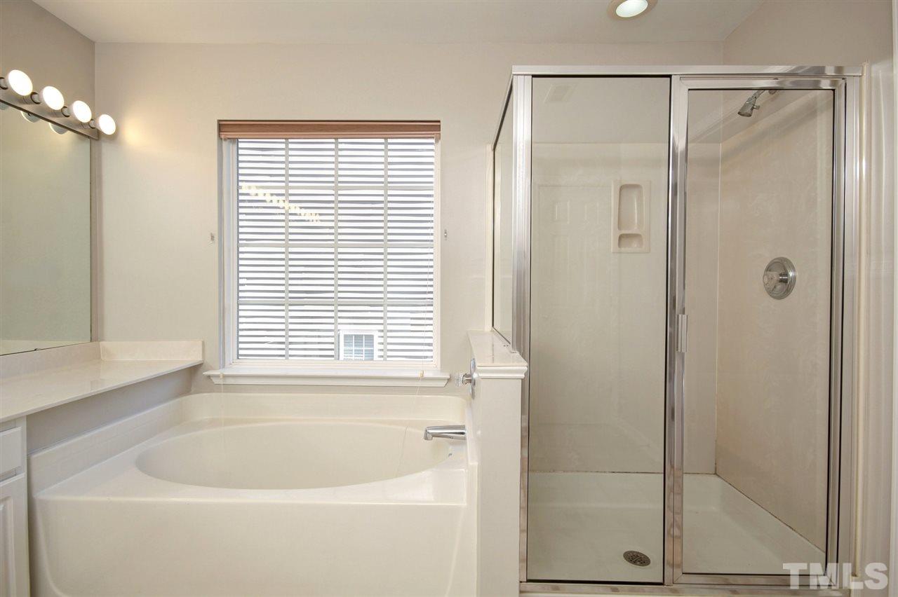 7444 Lagrange Drive Raleigh, NC 27613 - Photo 19 of 30 a white bath tub sitting next to a window