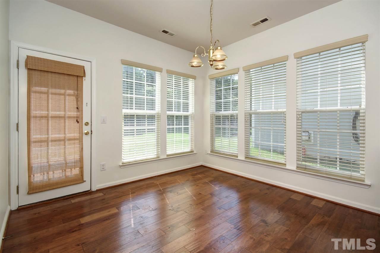 7444 Lagrange Drive Raleigh, NC 27613 - Photo 10 of 30 a view of an empty room with wooden floor and a window
