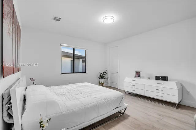 a bedroom with two beds and a window